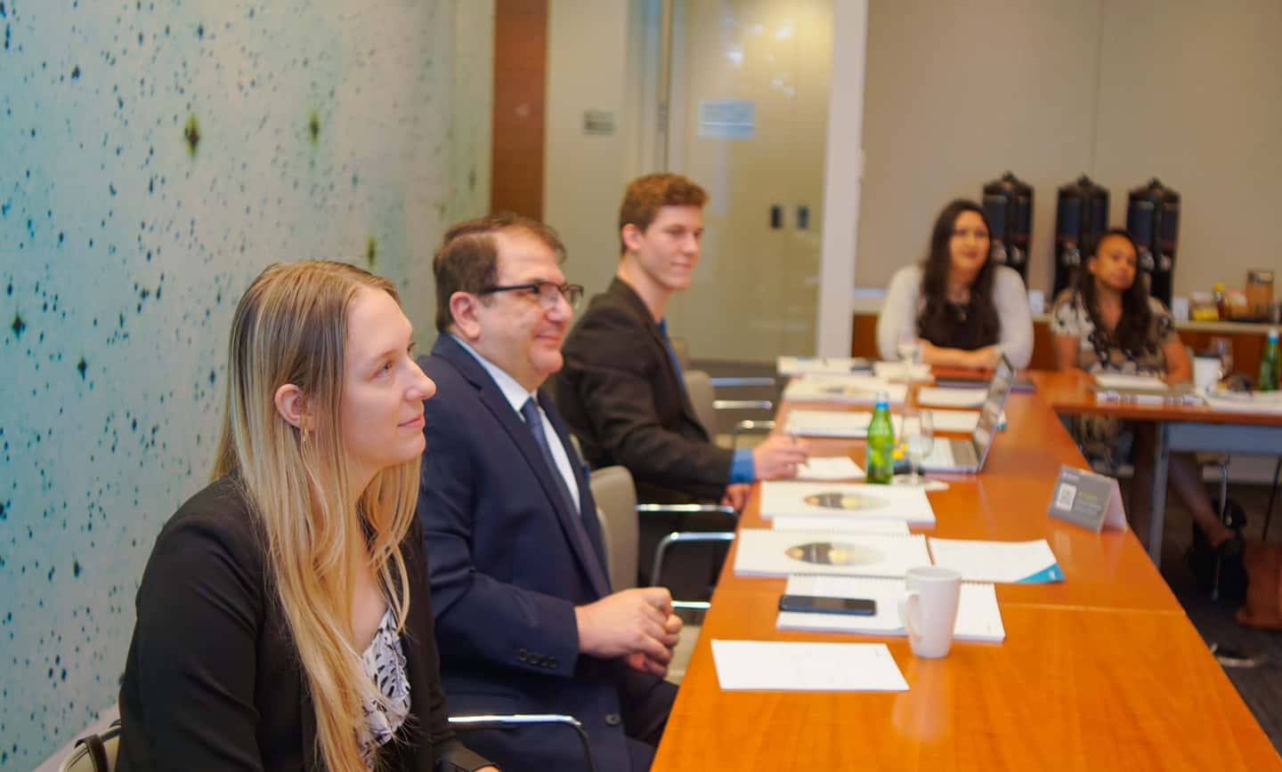 A HavenStone advisor reviewing business tax strategy with clients across the table