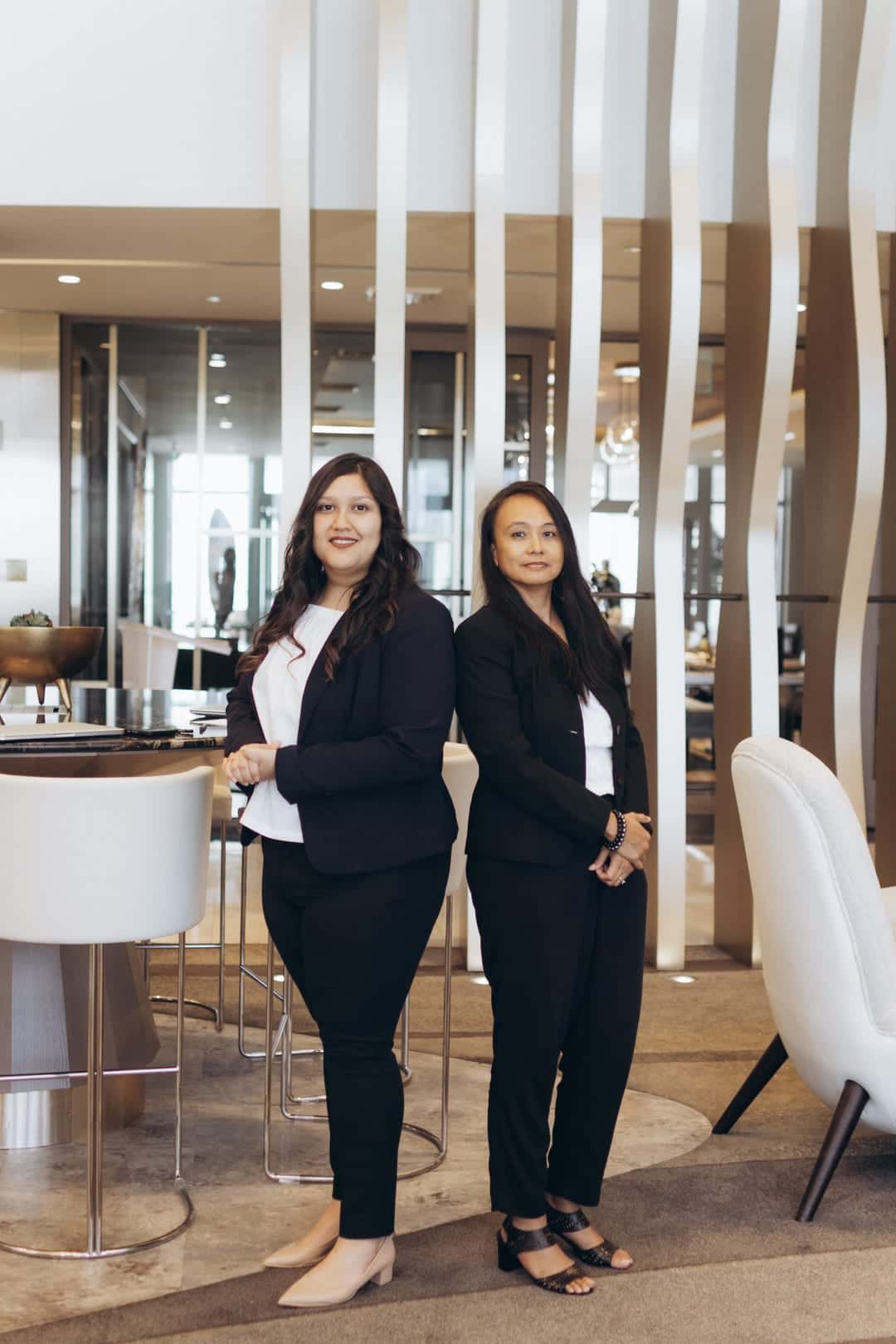 Two HavenStone advisors standing together in a modern office lobby