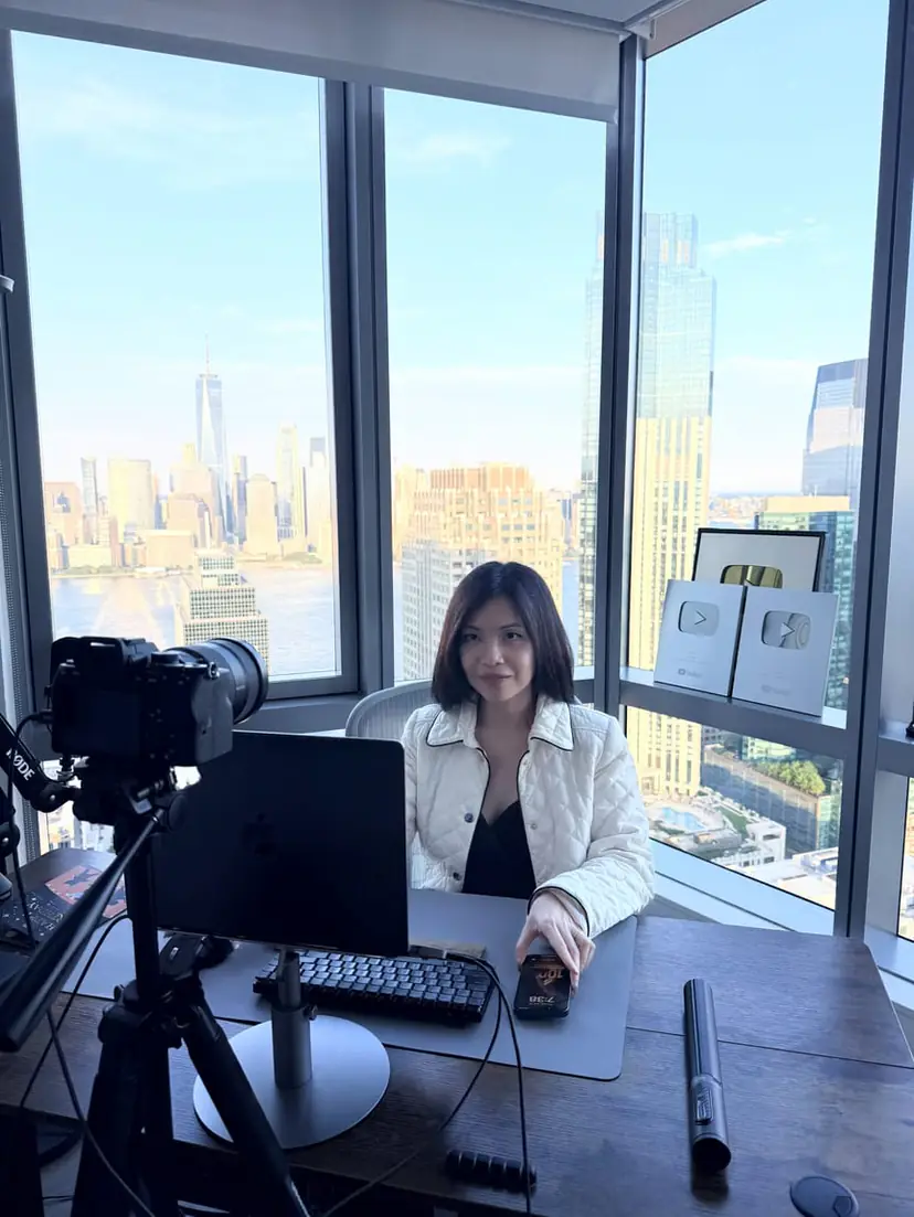 Mia Anne Reeves filming educational content with a city skyline behind her