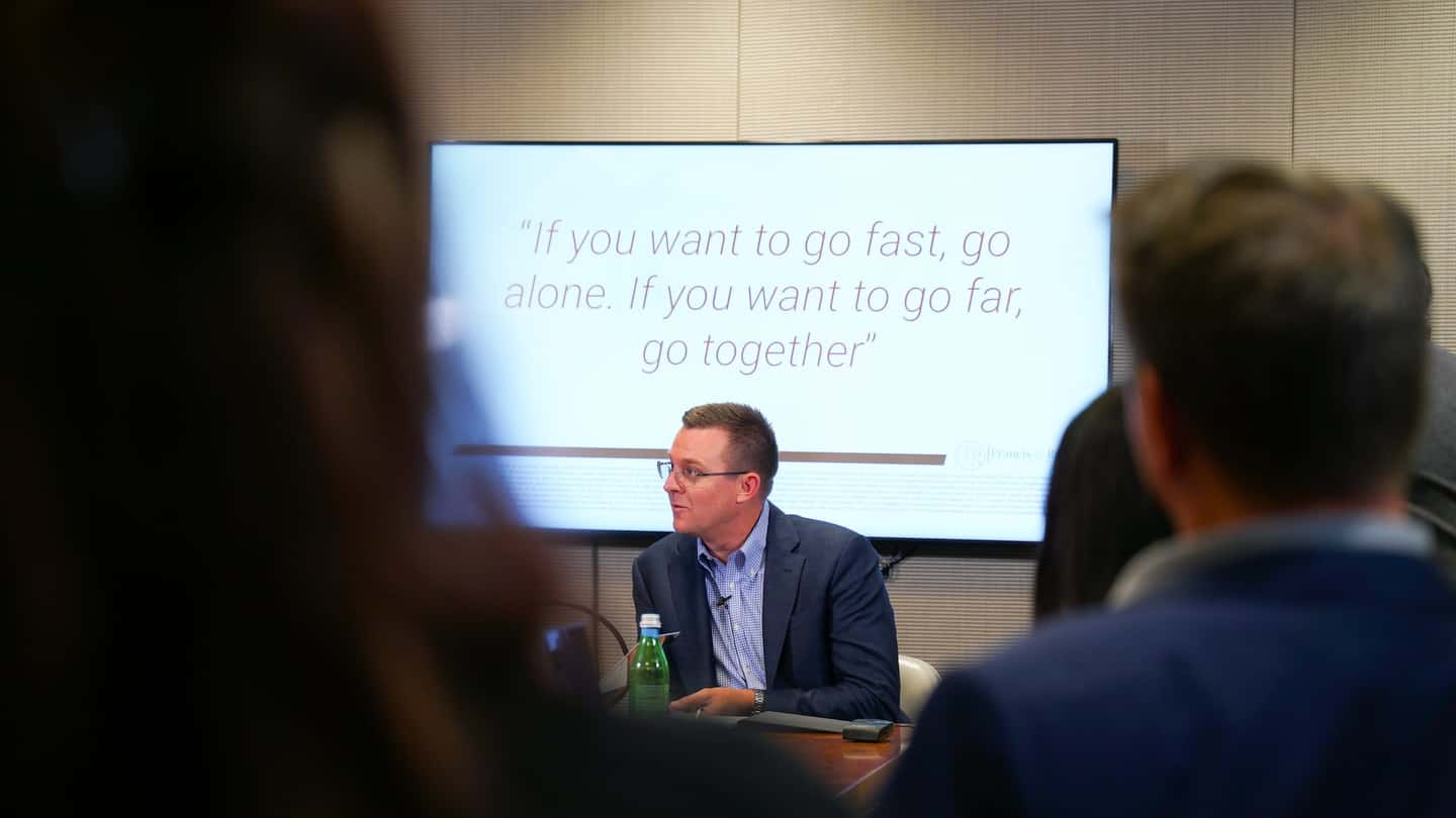 A HavenStone leader speaking to the team in a boardroom presentation