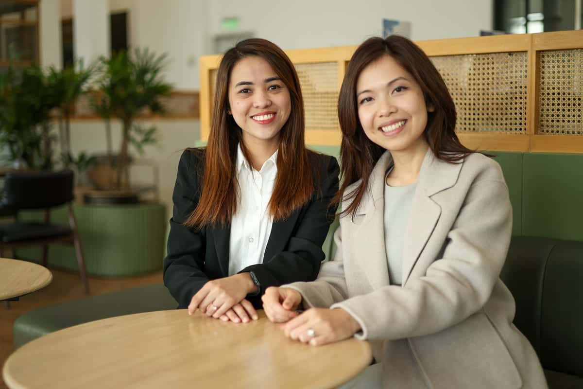 Two HavenStone team members smiling together at a table