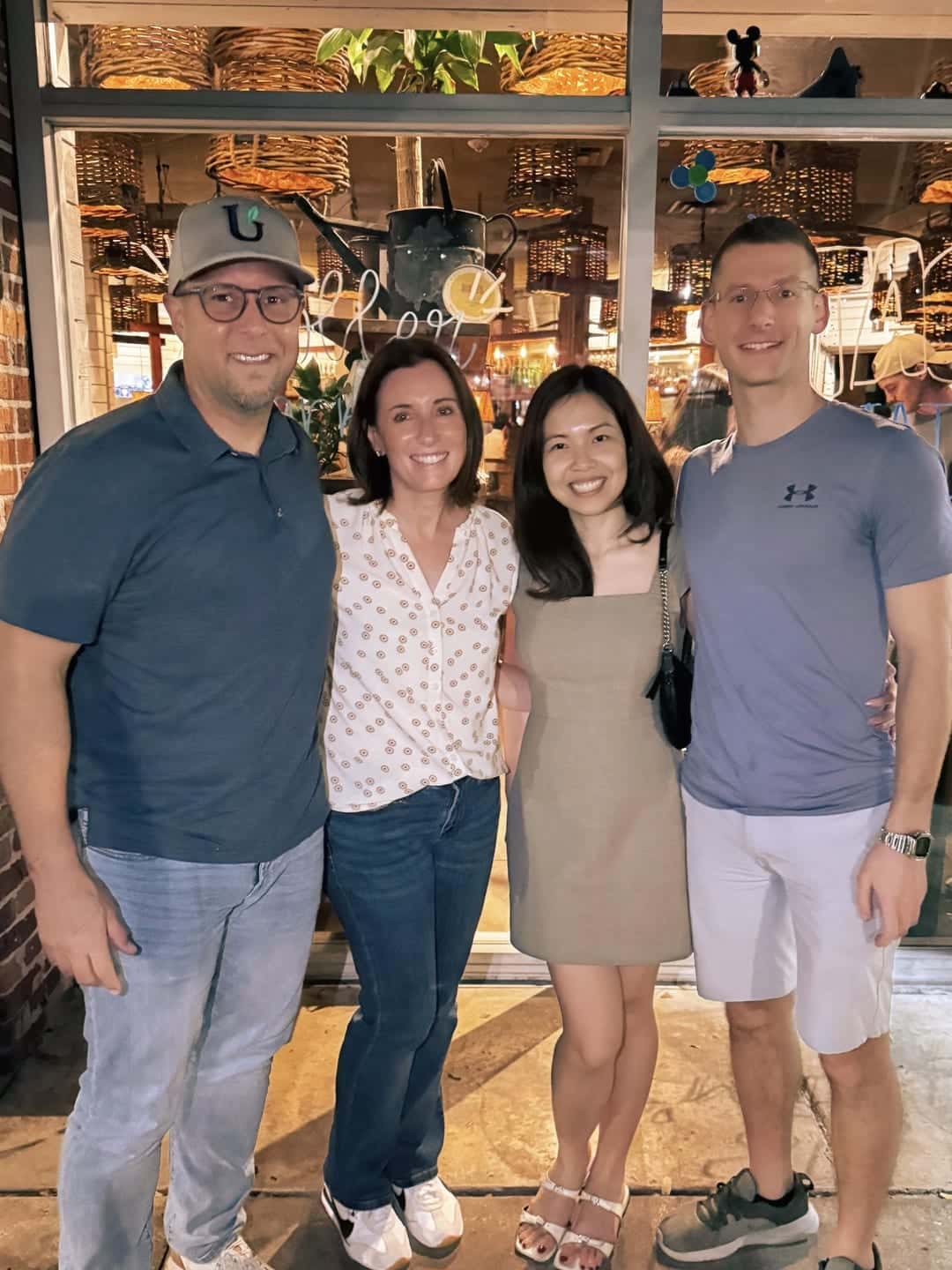 HavenStone team members smiling together outside a restaurant in the evening